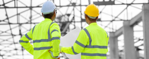 Construction,Worker,Discussing,Project,Details,At,Building,Site.